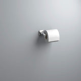 Toilet paper holder with a roll of toilet paper on a plain wall