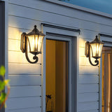 Two illuminated outdoor wall lights on a building facade.
