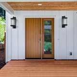 Wooden front door with glass panels on a white wall with wooden accents