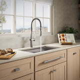 Modern kitchen with a sink and faucet, light wood cabinets, and a window view.