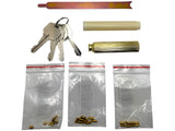 Collection of keys, cylindrical objects, and small metal parts on a white background
