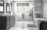 Modern bathroom with gray vanity, freestanding bathtub, and large window.