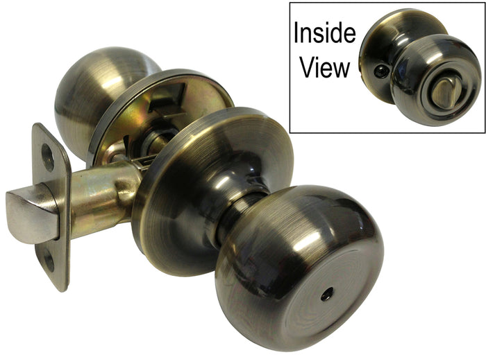 A pair of antique brass round door knobs with the interior view shown in the inset picture.