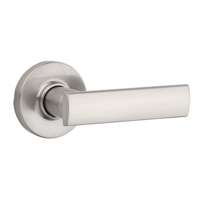 A satin nickel finish passage door handle from the Vedani collection with round rosettes.