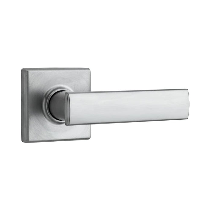 A satin chrome finish passage door handle from the Vedani collection with square rosettes.