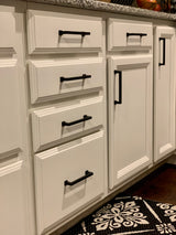 black cabinet pulls on white cabinetry