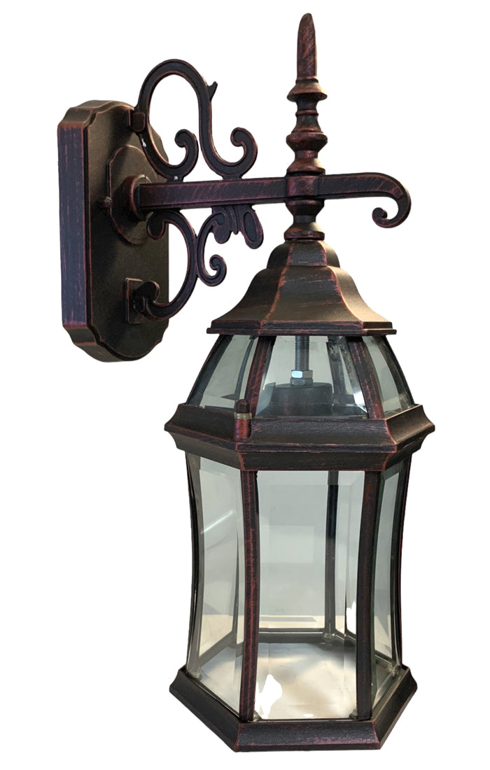 A red and black finish die cast aluminum outdoor wall sconce with smooth beveled glass. The fixture is mounted on a wall with a scroll design arm.