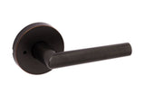 A Venetian bronze round privacy door lever from the Kwikset Milan Collection.