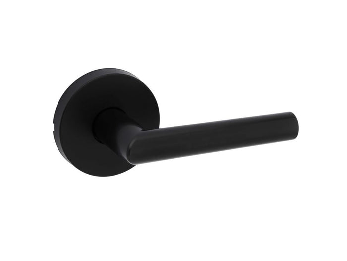 Matte black round passage door lever with round rosettes, part of the Kwikset Milan Collection.