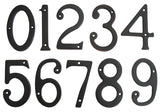 A set of metal house numbers in oil rubbed bronze finish, displaying the digits 0 through 9.